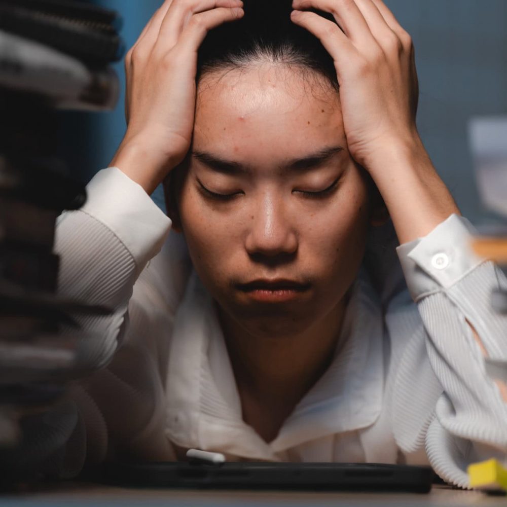 Late-night freelancer, Dedicated Asian woman working overtime on laptop computer, meeting deadlines in the sleepy Night, Businesswoman burning the midnight to working hard, sleep at working desk